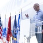 Jeff Bezos speaking at a podium.