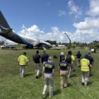 NTSB_investigators_at_the_site_of_the_21_Air_Flight_7598_runway_excursion_at_MIA