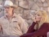Beth smokes while leaning against a wooden fence with Zachariah standing behind