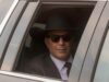 Kevin Costner in a limo with a large cowboy hat on