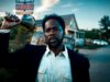 Harold Perrineau as Boyd Stevens rings a bell in front of a dilapidated motel in From